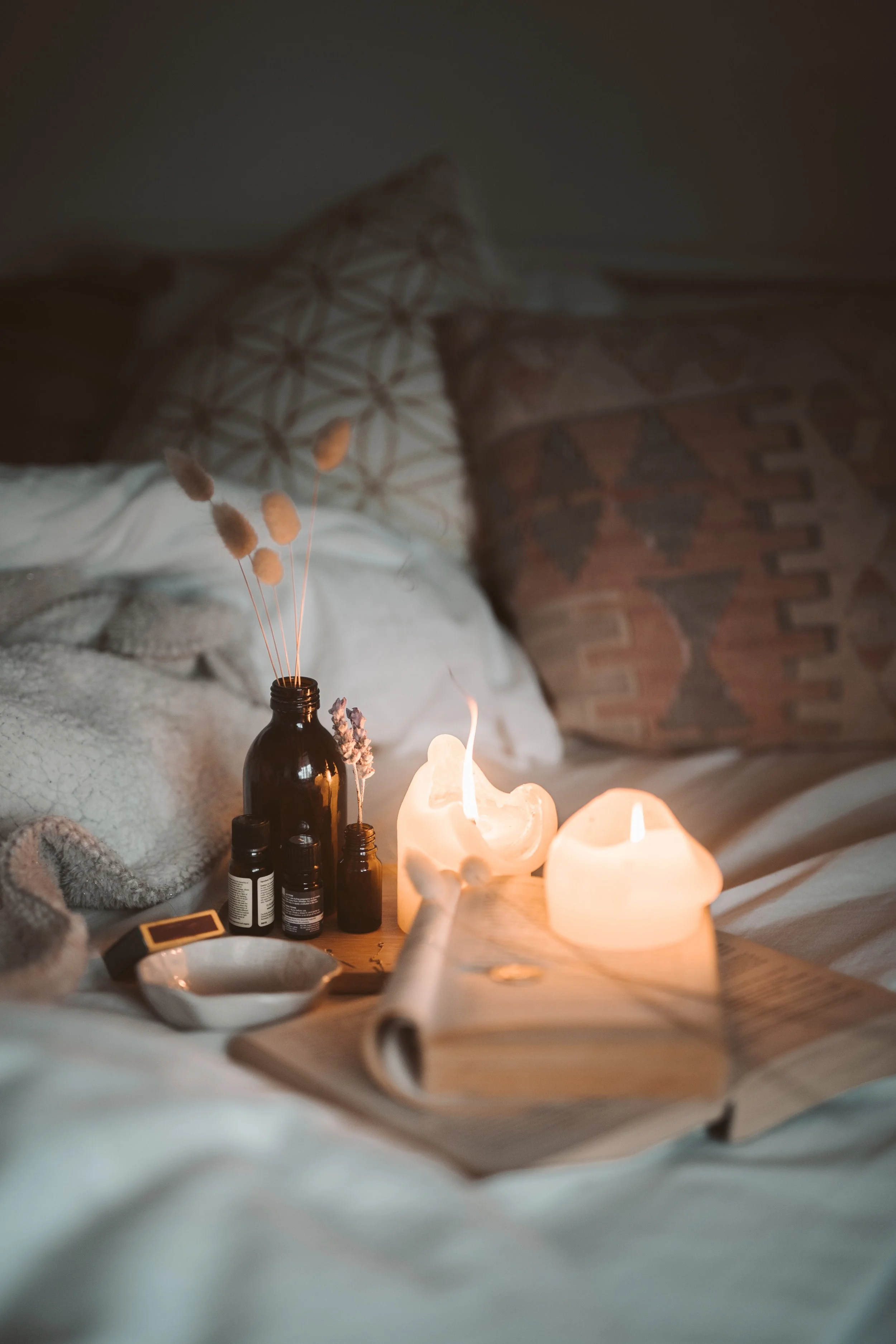 Warm, meditative setting with candles and essential oils